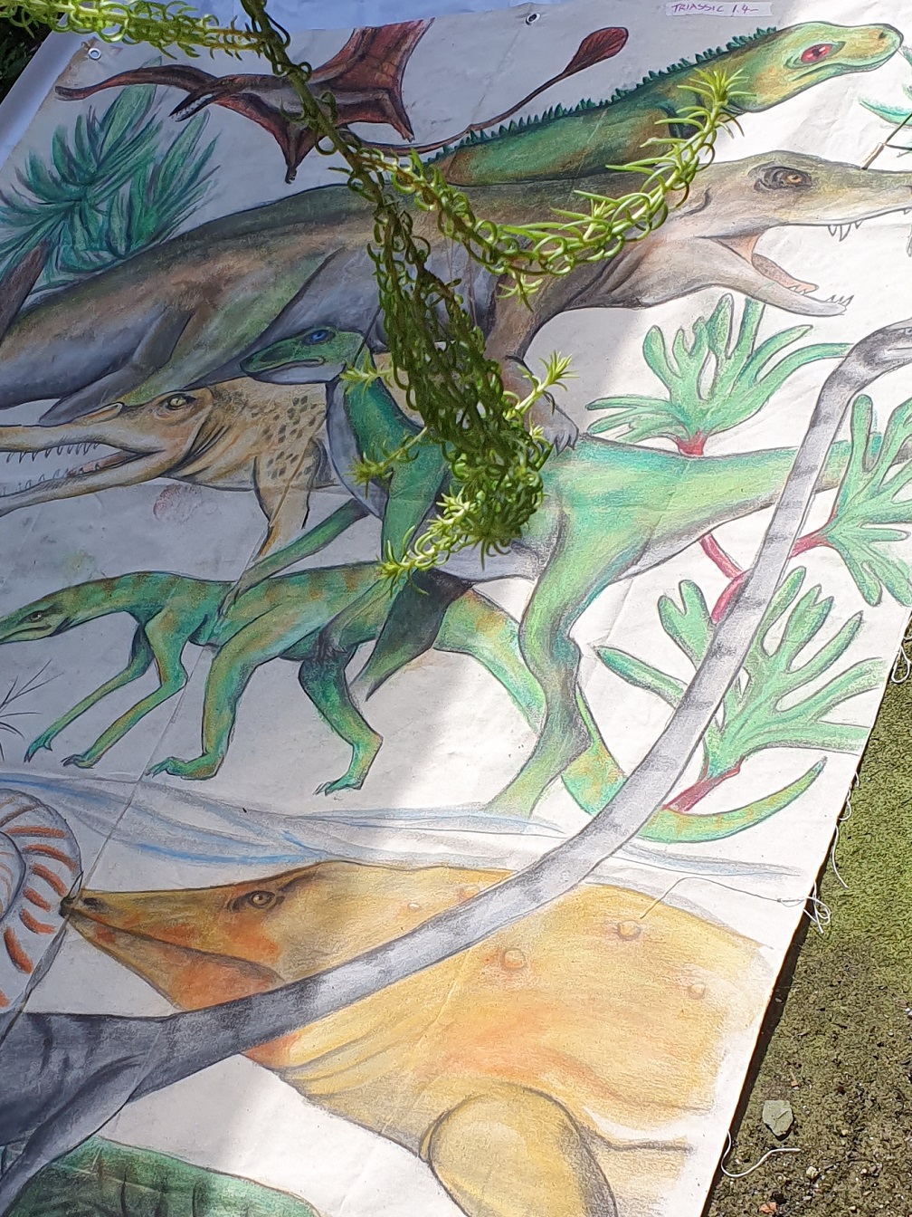 Illustrations of dinosaurs on a mural as part of the Two Minutes To Midnight exhibition.