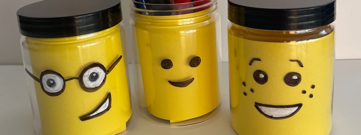 A picture shows three jars with LEGO® faces made with card. 