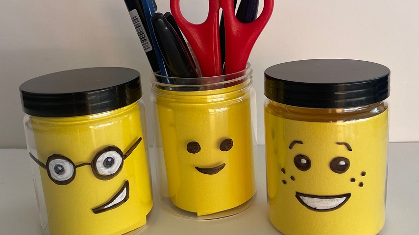 A picture shows three jars with LEGO® faces made with card.