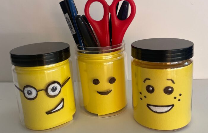 A picture shows three jars with LEGO® faces made with card.