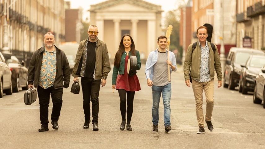 The Irish House Party band walking in the street.