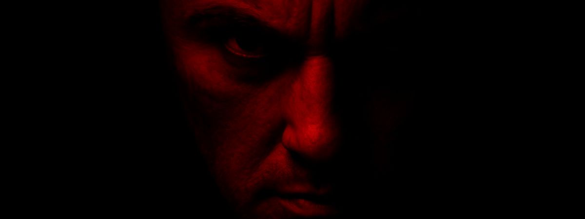 A person's face in red looks pensive against a dark background in a promotional image for Crime Viral: Can You Catch A Serial Killer?