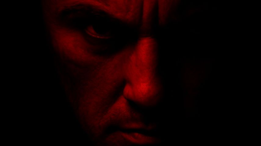 A person's face in red looks pensive against a dark background in a promotional image for Crime Viral: Can You Catch A Serial Killer?