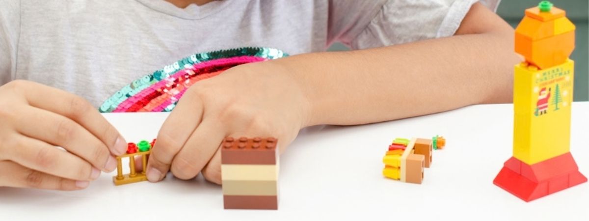 An image of a child playing with LEGO®.
