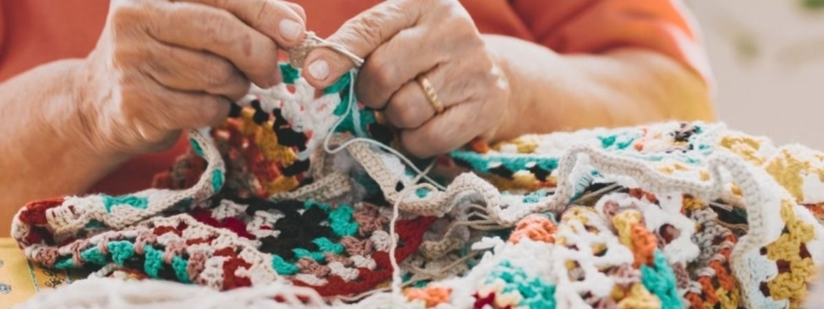 A close-up of a person knitting.